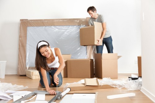 Professional movers packing a living room