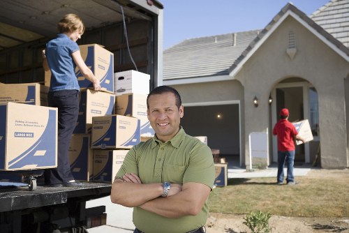 Movers loading items into a van