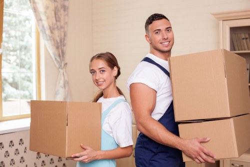 Professional mover assisting with packing in a home