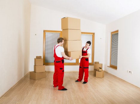 Movers packing office furniture for relocation